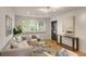 Inviting living room with hardwood floors, neutral furniture, and a view to the front yard at 7 Logan St # F, Charleston, SC 29401