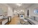 Open-concept living room connecting to a modern kitchen and features stylish neutral decor at 7 Logan St # F, Charleston, SC 29401
