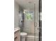 Glass shower with window, white tiling, and shower head at 7 Logan St # F, Charleston, SC 29401