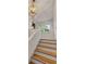 Bright stairway featuring hardwood steps, white risers, and a statement light fixture at 7 Logan St # F, Charleston, SC 29401