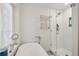 Modern bathroom featuring a soaking tub and a glass-enclosed shower with white subway tile at 728 N Godfrey Park Pl, Charleston, SC 29407