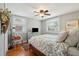 Bright bedroom with natural light, hardwood floors, and a comfortable seating area at 728 N Godfrey Park Pl, Charleston, SC 29407