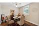 Inviting dining area with a glass table, upholstered chairs, and a decorative ceiling fan at 728 N Godfrey Park Pl, Charleston, SC 29407