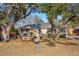 Charming single-story home with a well-manicured lawn and mature trees shading the front yard at 728 N Godfrey Park Pl, Charleston, SC 29407