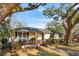 Charming single-story home with a cozy front porch, beautiful landscaping, and mature shade trees in a lovely neighborhood at 728 N Godfrey Park Pl, Charleston, SC 29407