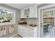 Laundry room with white cabinets, granite counters, and convenient outdoor access at 728 N Godfrey Park Pl, Charleston, SC 29407