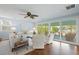 Bright living room with large windows, light walls, comfortable seating, and views of the outdoors at 728 N Godfrey Park Pl, Charleston, SC 29407