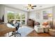 Bright home office with desk, chair, and a seating area overlooking backyard at 728 N Godfrey Park Pl, Charleston, SC 29407