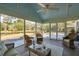 Inviting screened-in porch with wicker furniture, overhead fan, and relaxing views at 728 N Godfrey Park Pl, Charleston, SC 29407