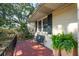 Welcoming front porch with tile flooring, comfortable bench, and lush potted plants that create an inviting entrance at 728 N Godfrey Park Pl, Charleston, SC 29407