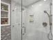 Close-up view of bathroom shower featuring glass doors and built-in shelving at 728 N Godfrey Park Pl, Charleston, SC 29407