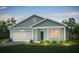 Charming single-story home with light green siding, white trim, and a well-manicured lawn at 742 Meadowbrook Ln, Summerville, SC 29486