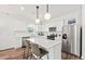 Modern kitchen with white cabinets, stainless steel appliances, an island with seating and pendant lights at 742 Meadowbrook Ln, Summerville, SC 29486