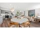 Bright, open-concept living space with modern lighting, wood floors and an accent wall at 746 Meadowbrook Lane, Summerville, SC 29486