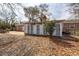 Spacious backyard featuring a concrete patio, sunroom, and a wooden picnic table at 8 Shrewsbury Rd, Charleston, SC 29407