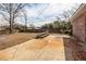 A leaf-covered backyard features a picnic table and a concrete patio at 8 Shrewsbury Rd, Charleston, SC 29407