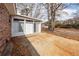 Brick home with a sunroom and concrete patio in a leaf covered backyard at 8 Shrewsbury Rd, Charleston, SC 29407