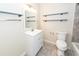 Bathroom with white vanity, modern faucet, and open shelving at 8 Shrewsbury Rd, Charleston, SC 29407