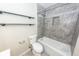 Updated bathroom with gray tile, modern shelves, and updated fixtures at 8 Shrewsbury Rd, Charleston, SC 29407