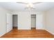 Inviting bedroom featuring hardwood floors, closet and easy bathroom access at 8 Shrewsbury Rd, Charleston, SC 29407