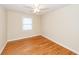 Bright bedroom featuring hardwood floors, ceiling fan, and a window with blinds at 8 Shrewsbury Rd, Charleston, SC 29407