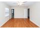 A spacious bedroom with hardwood floors, ceiling fan, two windows and neutral-colored walls at 8 Shrewsbury Rd, Charleston, SC 29407