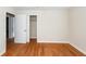 Bedroom with hardwood floors, closet, and open door to hallway at 8 Shrewsbury Rd, Charleston, SC 29407