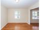 Bright dining room with hardwood floors, a classic light, and a window at 8 Shrewsbury Rd, Charleston, SC 29407