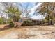 Charming brick home with well-maintained landscaping and mature trees in the front yard at 8 Shrewsbury Rd, Charleston, SC 29407