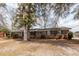 Traditional brick home showcasing shuttered windows and mature trees on a spacious lot at 8 Shrewsbury Rd, Charleston, SC 29407