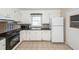 Traditional kitchen with white cabinets, black counters, tile flooring, and stainless microwave at 8 Shrewsbury Rd, Charleston, SC 29407