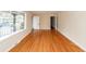 Spacious living room featuring gleaming hardwood floors, a window, and an open doorway at 8 Shrewsbury Rd, Charleston, SC 29407
