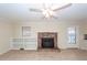 Living room features tile flooring, a brick fireplace, built-in shelving, and a ceiling fan at 8 Shrewsbury Rd, Charleston, SC 29407
