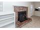 Living room featuring tile flooring, a brick fireplace, built-in shelving, and lots of light at 8 Shrewsbury Rd, Charleston, SC 29407