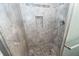 Tiled walk-in shower with decorative in-wall niche and mosaic pebble floor at 8 Shrewsbury Rd, Charleston, SC 29407
