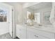 Bright bathroom featuring double sinks, white cabinets, modern fixtures, and natural lighting at 8745 Silver Perch Ln, North Charleston, SC 29420