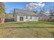 Backyard view of this home featuring a patio, lush green lawn, and privacy fence at 94 Dean Dr, Summerville, SC 29483
