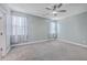 Bedroom features carpet, two windows dressed with curtains, a ceiling fan, and neutral paint at 94 Dean Dr, Summerville, SC 29483