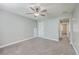 Bedroom featuring plush carpet, gray walls, ceiling fan, and neutral decor for versatile personalization at 94 Dean Dr, Summerville, SC 29483