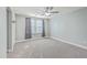 This bedroom offers soft gray walls, plush carpeting, and a large window to welcome natural light at 94 Dean Dr, Summerville, SC 29483