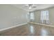Bright bedroom with wood flooring, neutral walls, and two windows offering natural light at 94 Dean Dr, Summerville, SC 29483