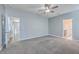 Neutral bedroom features a ceiling fan, plush carpet, and two doorways leading to other rooms at 94 Dean Dr, Summerville, SC 29483