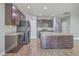 Spacious kitchen with dark wood cabinetry, stainless appliances, and granite countertops on the island at 94 Dean Dr, Summerville, SC 29483