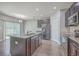 Kitchen with granite island, stainless steel appliances, dark cabinets, and a view into the breakfast nook at 94 Dean Dr, Summerville, SC 29483