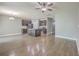 Open-concept living space with kitchen island, stainless appliances, and hardwood flooring throughout at 94 Dean Dr, Summerville, SC 29483