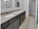 Bathroom with double sinks, granite countertops, dark cabinetry, and a view of the walk-in shower at 96 Dean Dr, Summerville, SC 29483