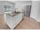 Bright kitchen featuring a granite island, stainless steel appliances and a window view at 96 Dean Dr, Summerville, SC 29483
