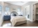 Comfortable bedroom with ensuite bath, hardwood floors, blue accents and plenty of natural light at 3945 Bulow Landing Rd, Hollywood, SC 29470