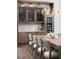 Dining room with a built-in bar area, wine fridge, hardwood floors, and modern lighting at 3945 Bulow Landing Rd, Hollywood, SC 29470
