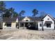 Charming new construction home featuring a metal roof and light yellow and white siding at 3945 Bulow Landing Rd, Hollywood, SC 29470